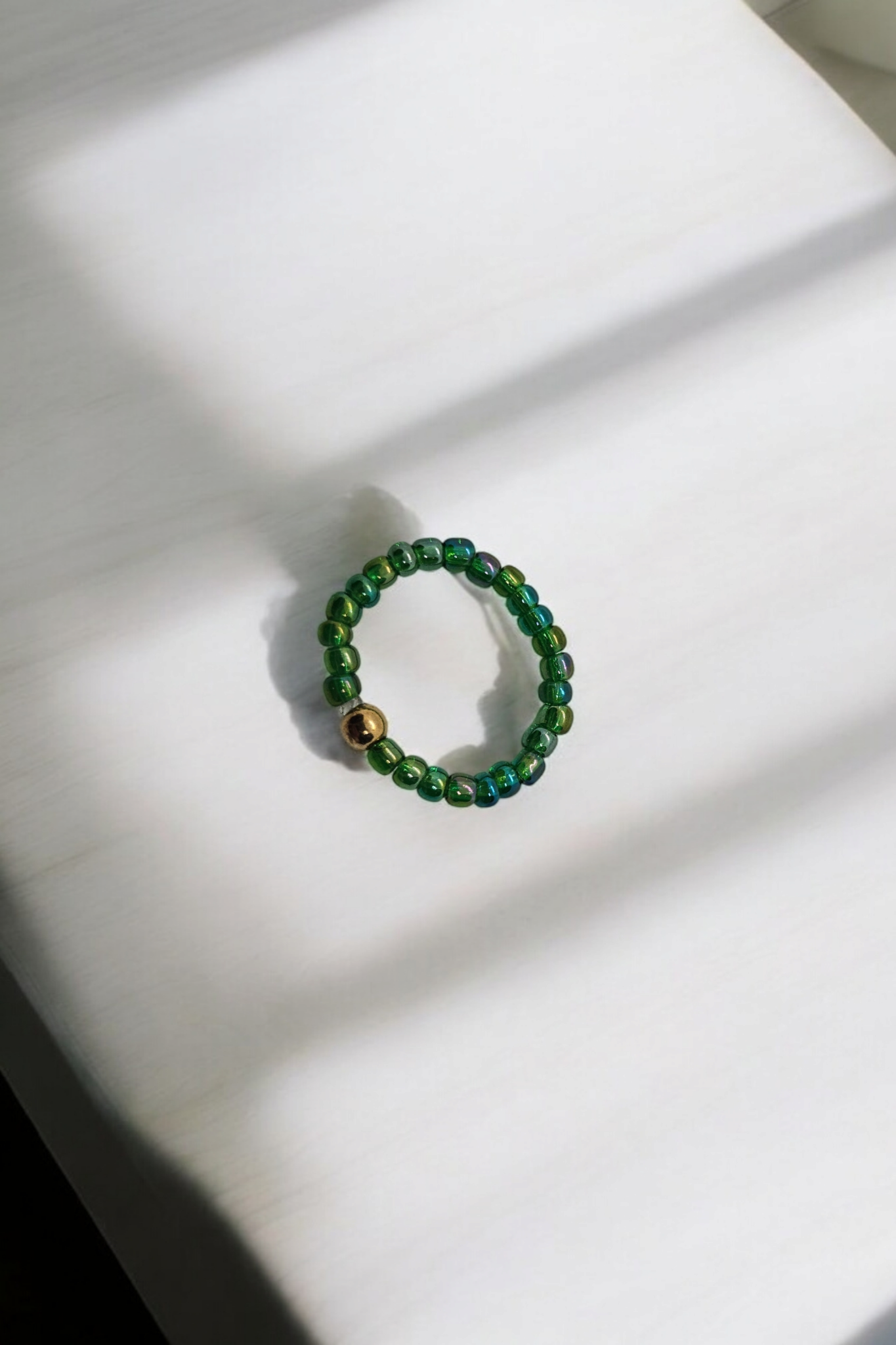 Groene  elastieken ring met gouden kralen one size 
